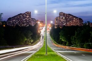 Long exposure of a highway in Chișinău showing light trails and urban skyline at night.