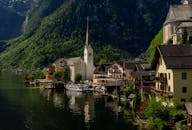 Charming view of Hallstatt with its iconic church by the lake against a backdrop of mountains.