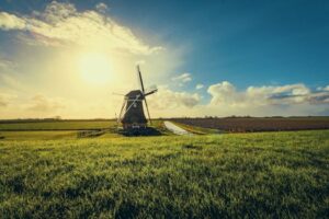 Beautiful windmill in Uithuizermeeden, Netherlands, surrounded by fields at sunset.